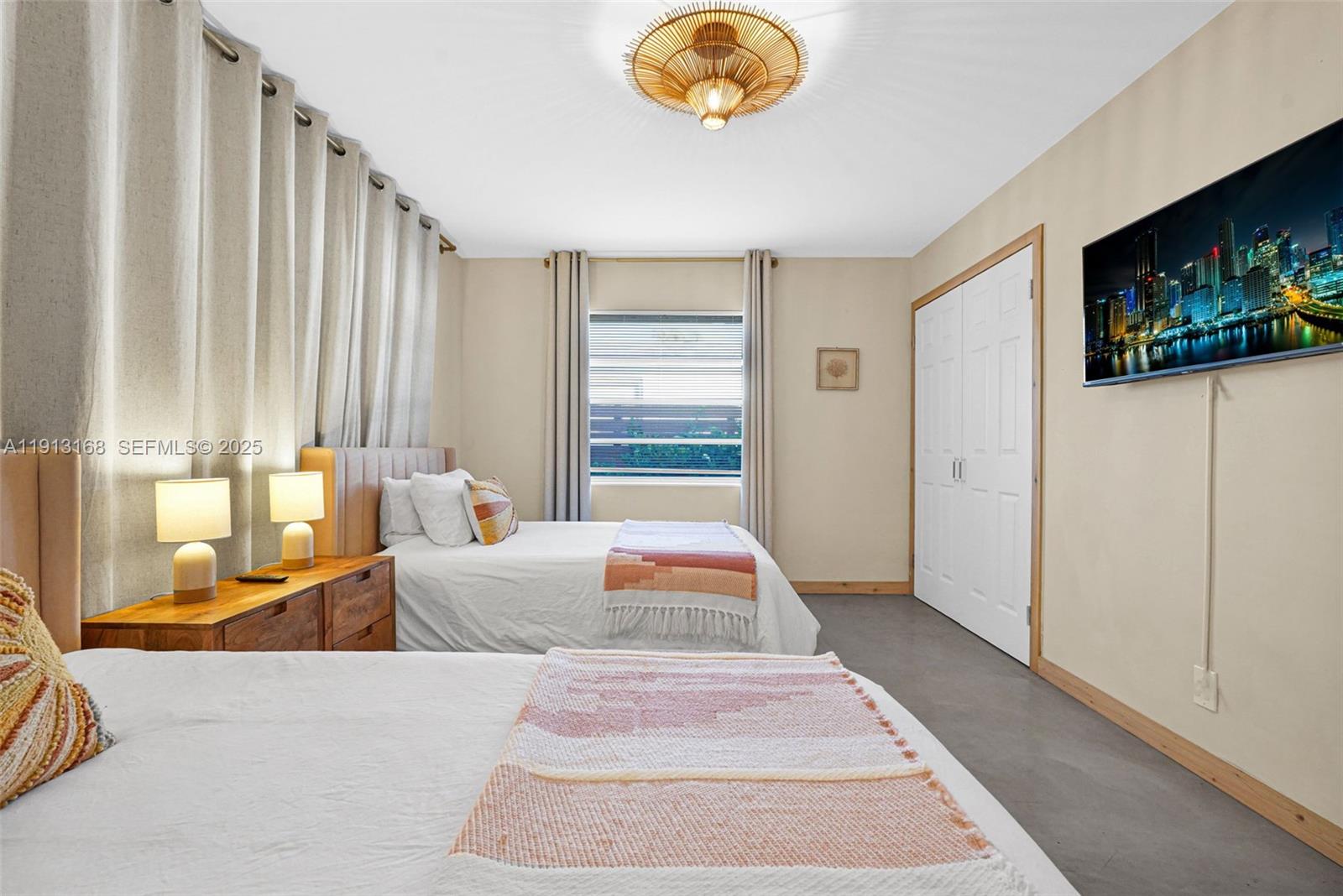 1012 Northeast 2nd Street Hallandale Beach, FL 33009 - Photo 24 of 65 a bedroom with a bed and a chandelier