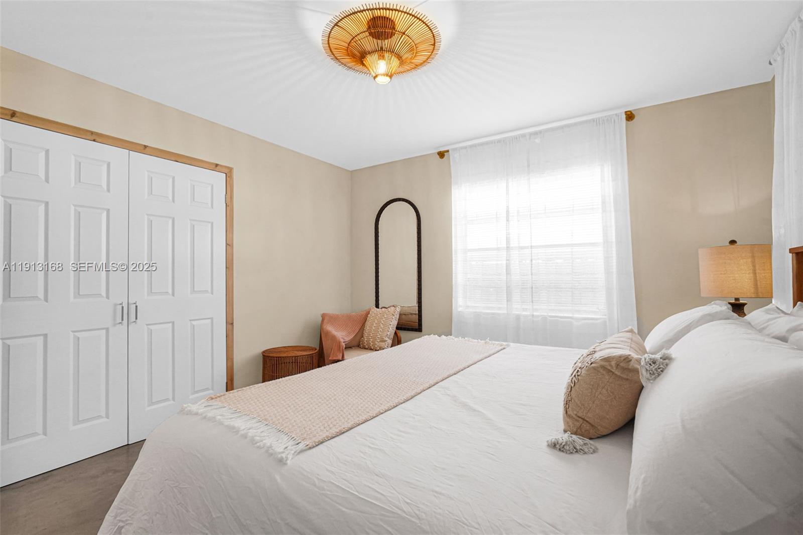 1012 Northeast 2nd Street Hallandale Beach, FL 33009 - Photo 27 of 65 a bedroom with a bed and a window