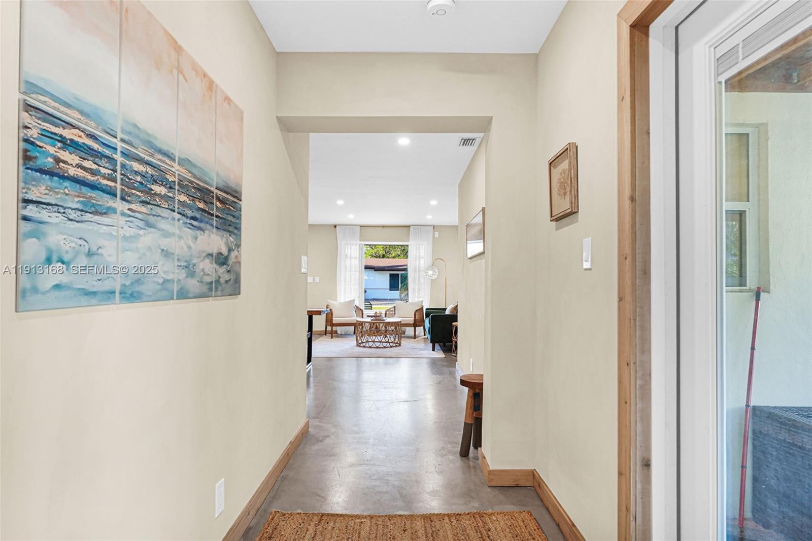 1012 Northeast 2nd Street Hallandale Beach, FL 33009 - Photo 33 of 65 a view of a hallway with wooden floor fireplace and living room