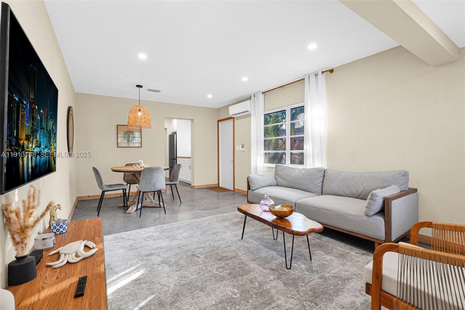 1012 Northeast 2nd Street Hallandale Beach, FL 33009 - Photo 38 of 65 a living room with furniture and a window