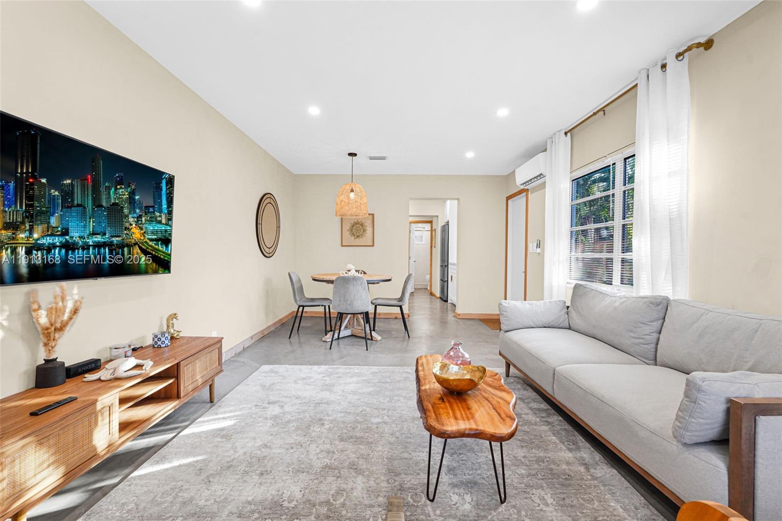 1012 Northeast 2nd Street Hallandale Beach, FL 33009 - Photo 39 of 65 a living room with furniture and a large window