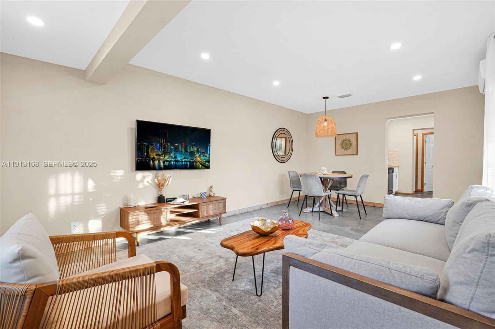 1012 Northeast 2nd Street Hallandale Beach, FL 33009 - Photo 40 of 65 a living room with furniture and a flat screen tv