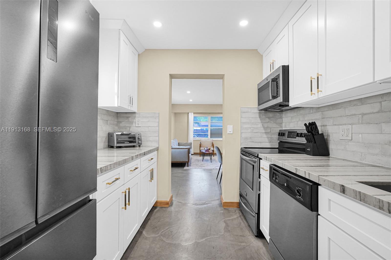 1012 Northeast 2nd Street Hallandale Beach, FL 33009 - Photo 42 of 65 a kitchen with cabinets and appliances