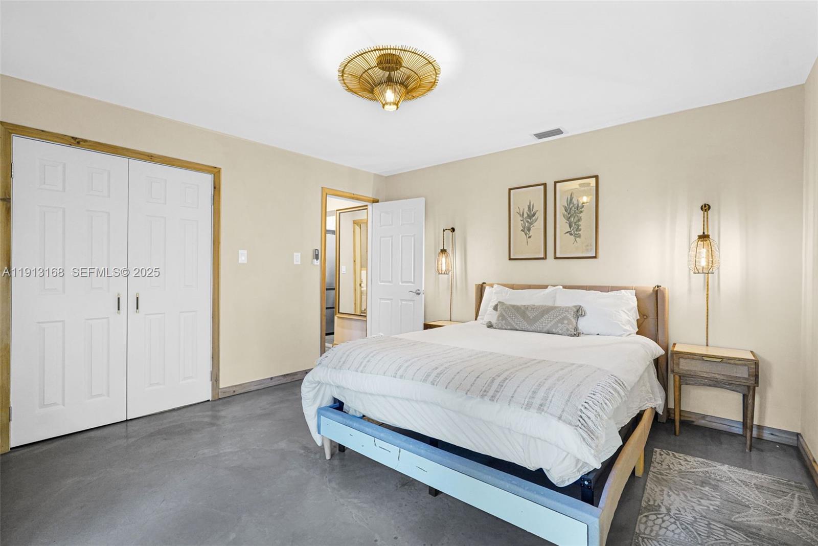 1012 Northeast 2nd Street Hallandale Beach, FL 33009 - Photo 48 of 65 a bedroom with a bed and a painting on the wall