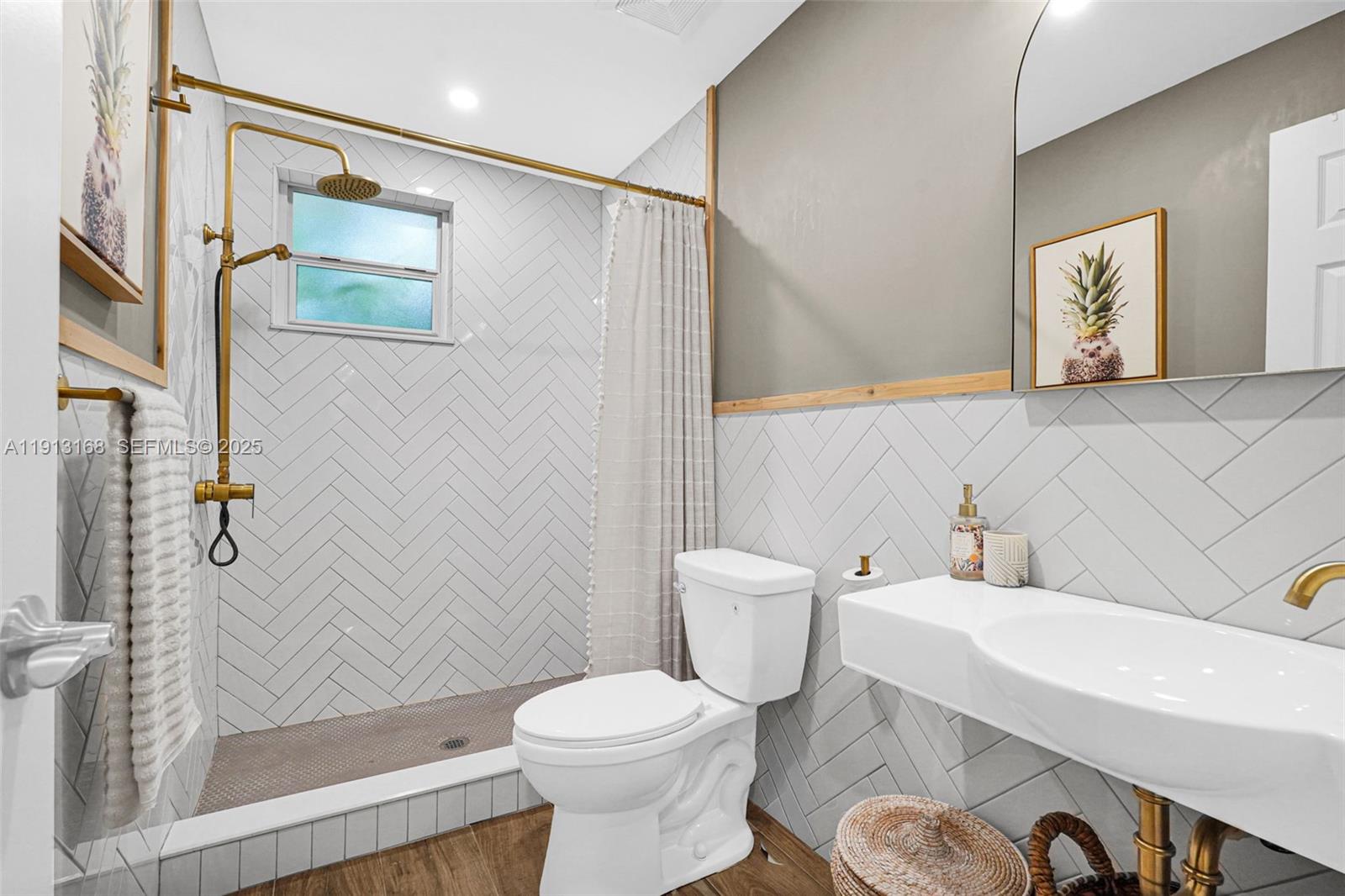 1012 Northeast 2nd Street Hallandale Beach, FL 33009 - Photo 49 of 65 a bathroom with a sink and a mirror