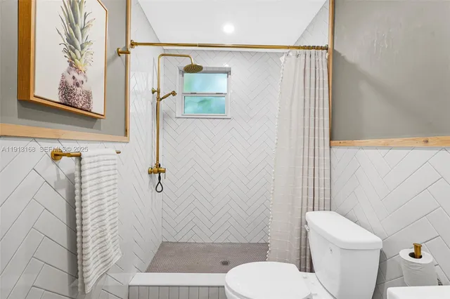 a picture of a bathroom with a white wall and a picture