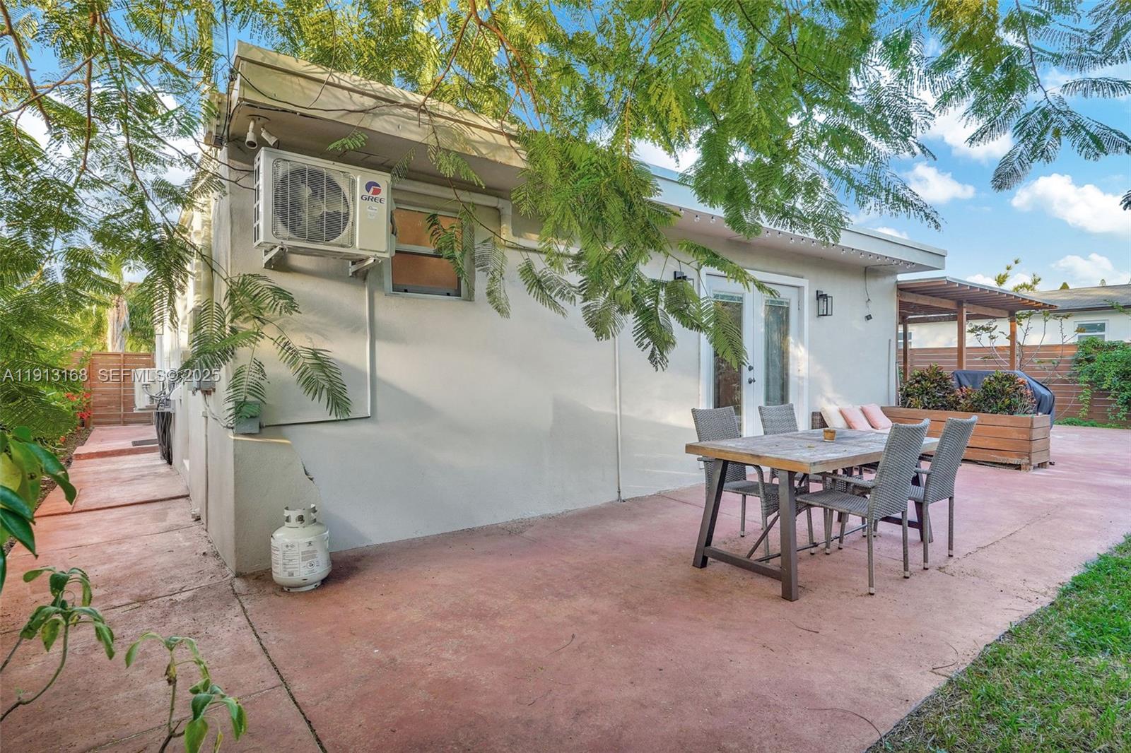1012 Northeast 2nd Street Hallandale Beach, FL 33009 - Photo 60 of 65 a view of a patio with table and chairs and potted plants