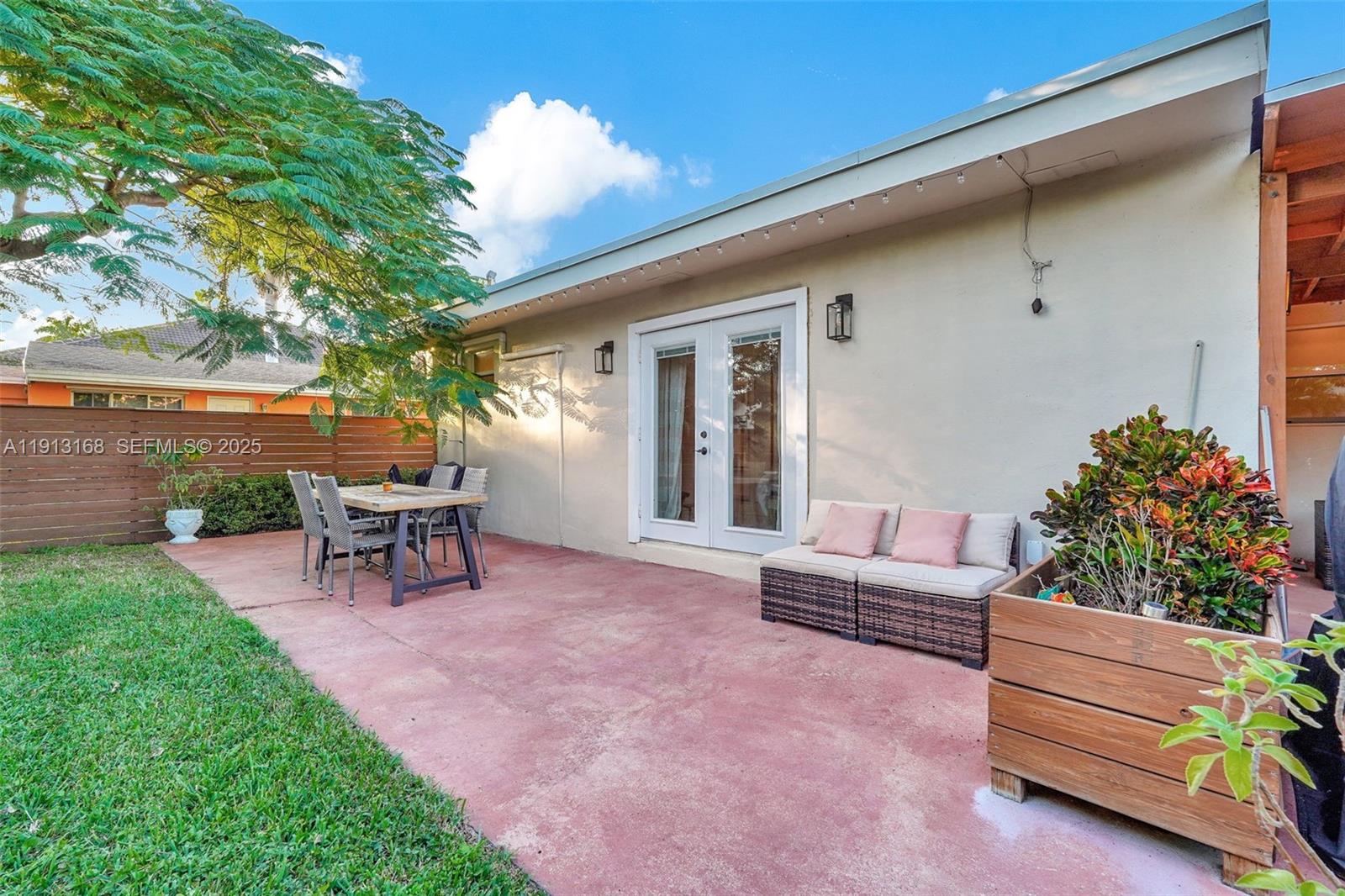 1012 Northeast 2nd Street Hallandale Beach, FL 33009 - Photo 61 of 65 a view of a house with a backyard and sitting area
