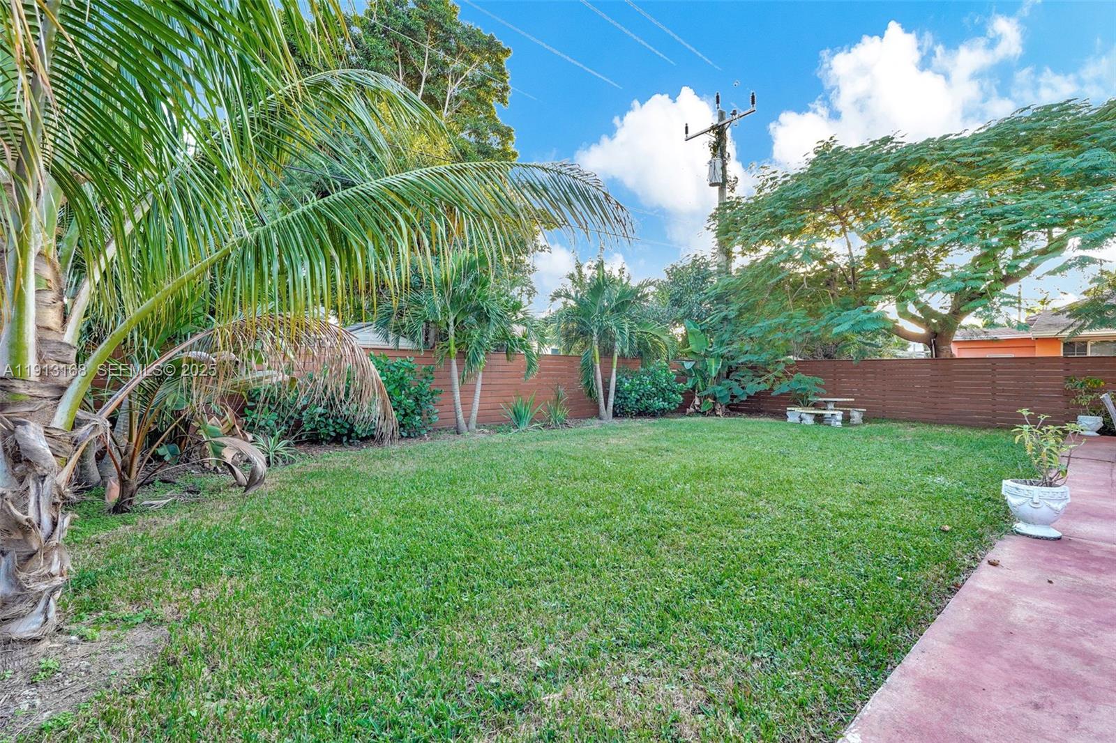 1012 Northeast 2nd Street Hallandale Beach, FL 33009 - Photo 63 of 65 a view of a garden with a plants and palm trees