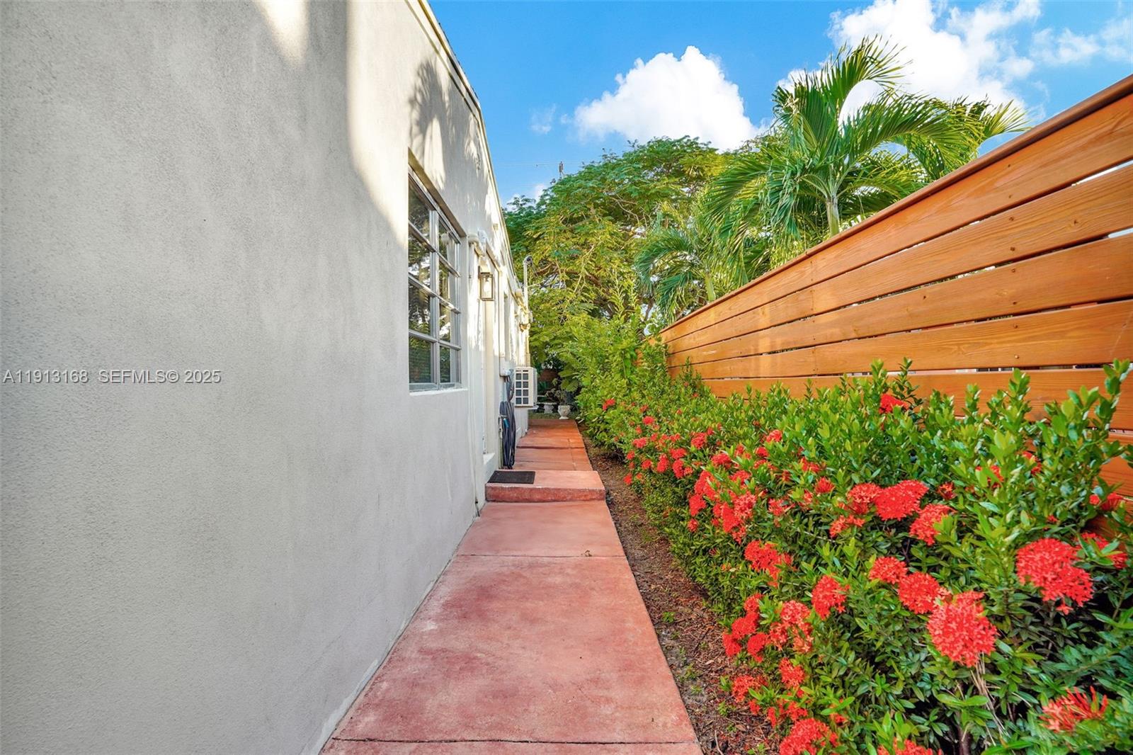 1012 Northeast 2nd Street Hallandale Beach, FL 33009 - Photo 64 of 65 a view of a pathway with a flower garden