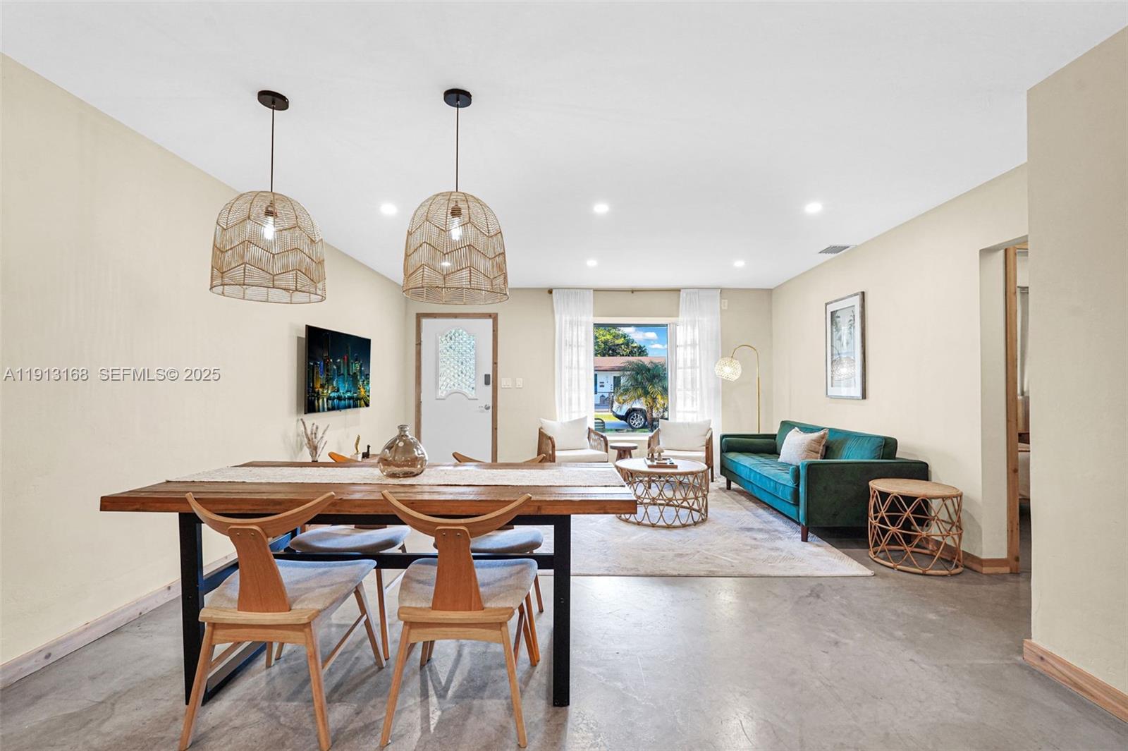 1012 Northeast 2nd Street Hallandale Beach, FL 33009 - Photo 9 of 65 a view of a dining room with furniture window and wooden floor