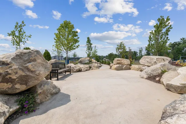 a view of a backyard with couches and a potted plant