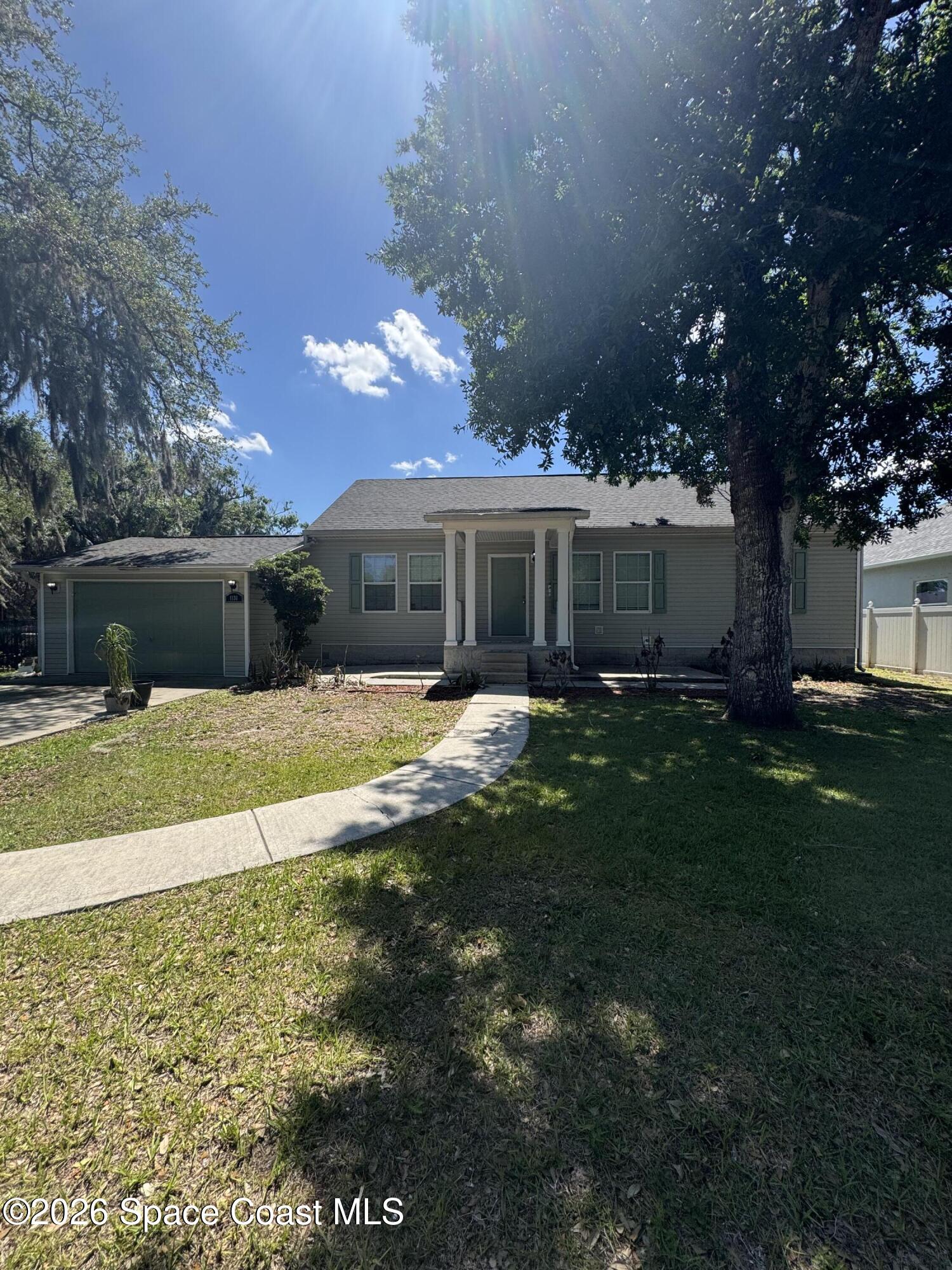 1130 Grapefruit Road Southeast Palm Bay, FL 32909 - Photo 2 of 14 front view of a house with a yard