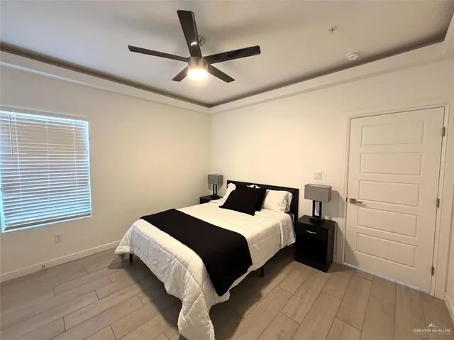 a bed room with a bed and a ceiling fan