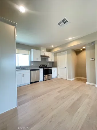 a view of a kitchen with a sink and a stove top oven
