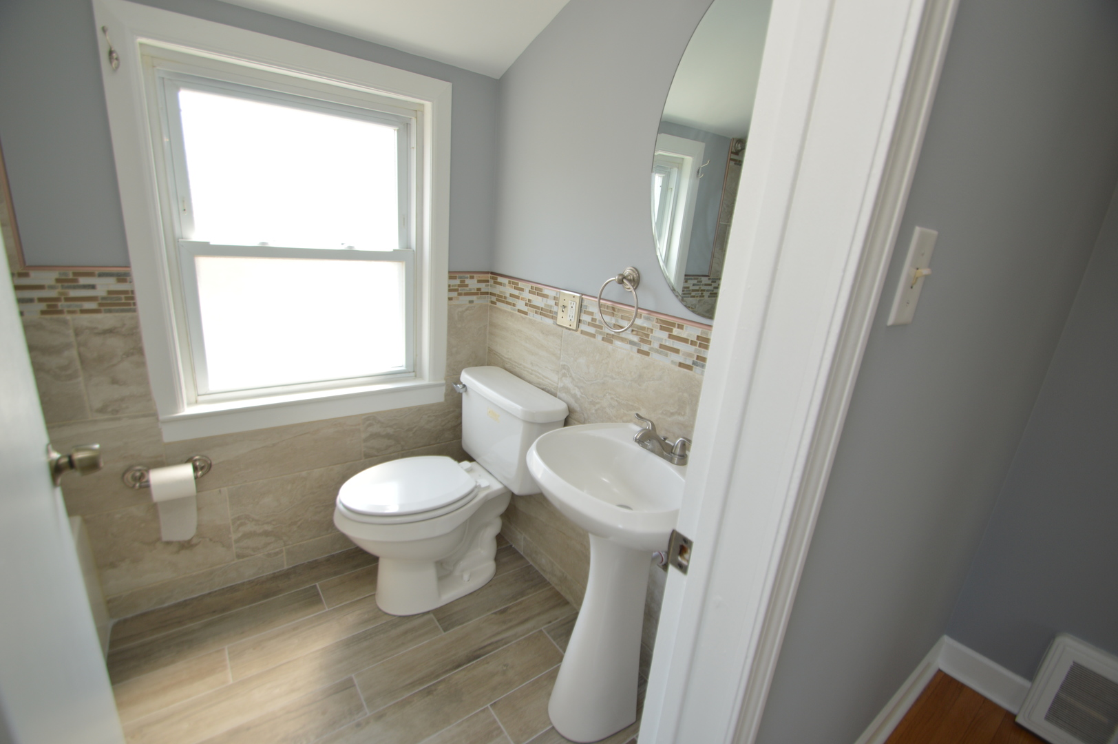 1517 Morris Avenue Berkeley, IL 60163 - Photo 18 of 35 a white toilet sitting next to a bathroom sink