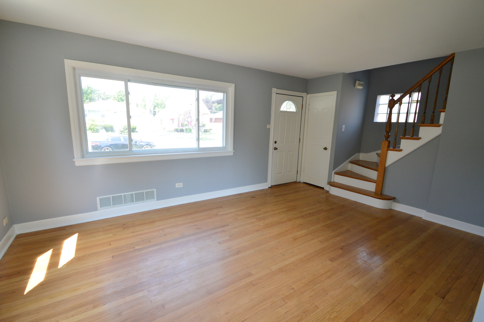 1517 Morris Avenue Berkeley, IL 60163 - Photo 3 of 35 a view of an empty room with wooden floor and a window