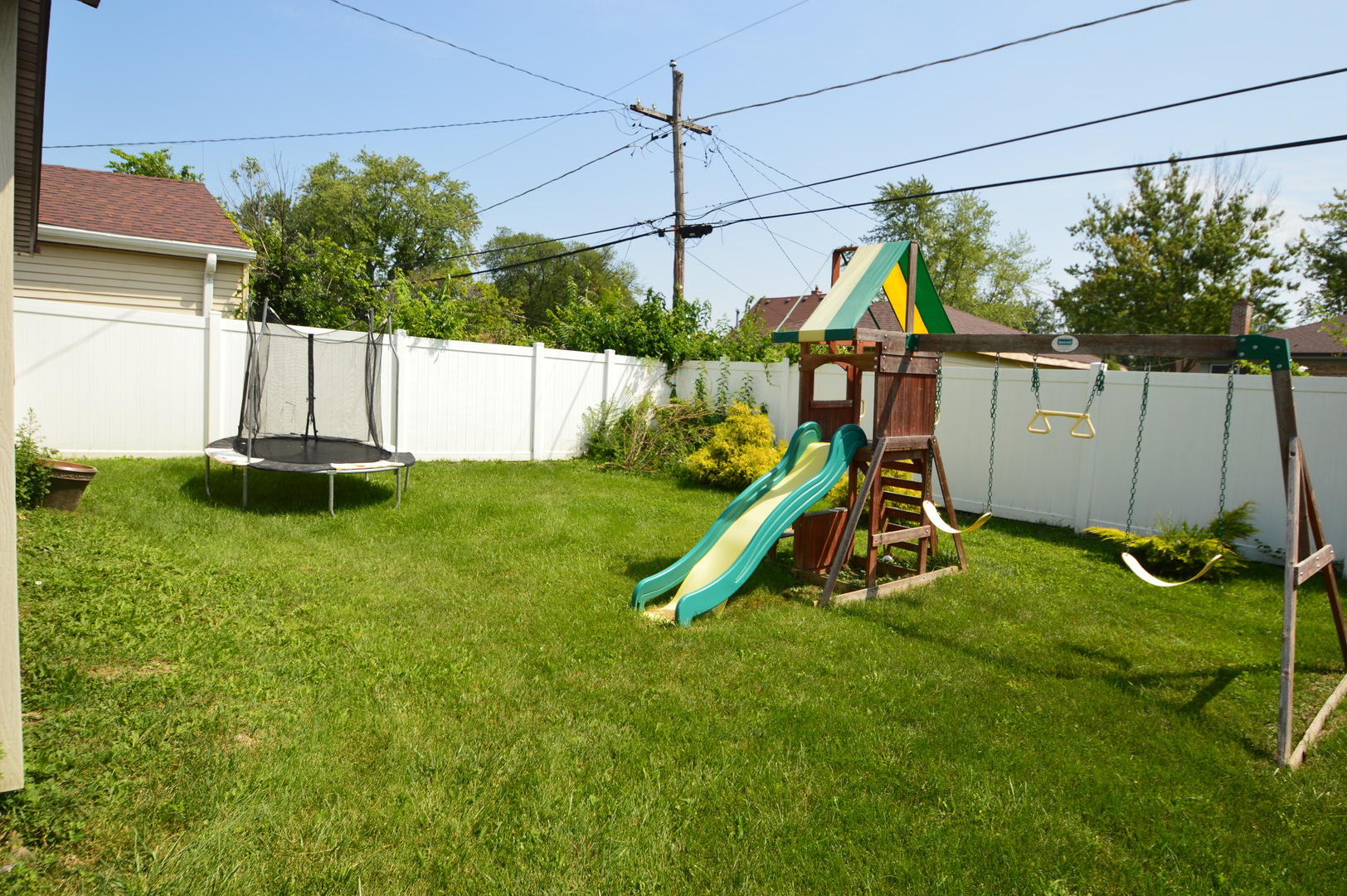 1517 Morris Avenue Berkeley, IL 60163 - Photo 31 of 35 a view of a backyard with a slide and a wooden fence
