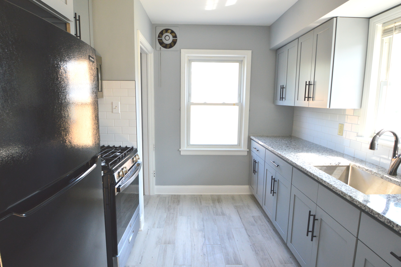 1517 Morris Avenue Berkeley, IL 60163 - Photo 7 of 35 a kitchen with a sink a window and appliances