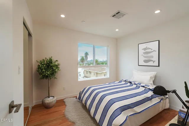 a bedroom with bed and window