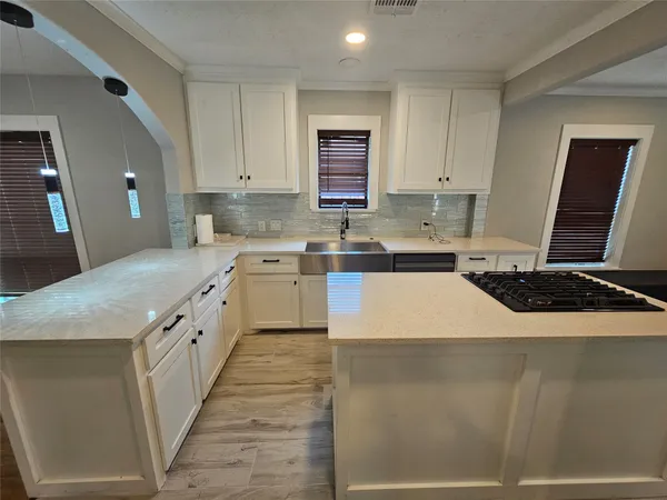 a large kitchen with stainless steel appliances granite countertop a sink and a stove