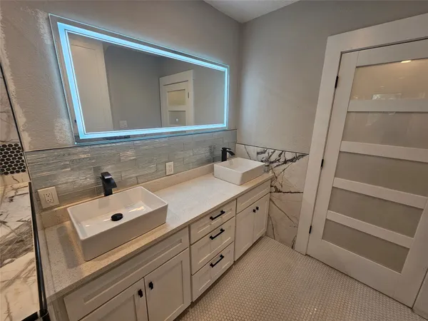 a bathroom with a sink and a mirror