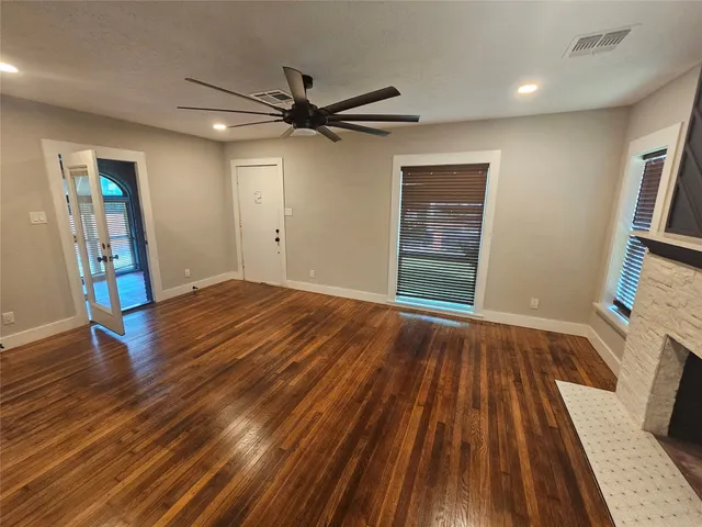 wooden floor in an empty room with a window