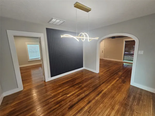 a view of a room with wooden floor