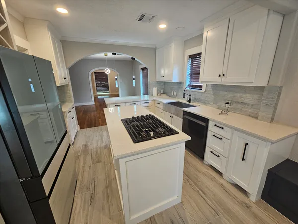 a kitchen with a sink stove and cabinets