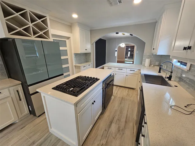 a kitchen with sink stove and refrigerator