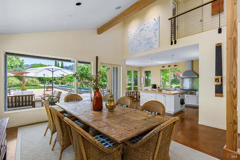 a living room with furniture a fireplace and a floor to ceiling window