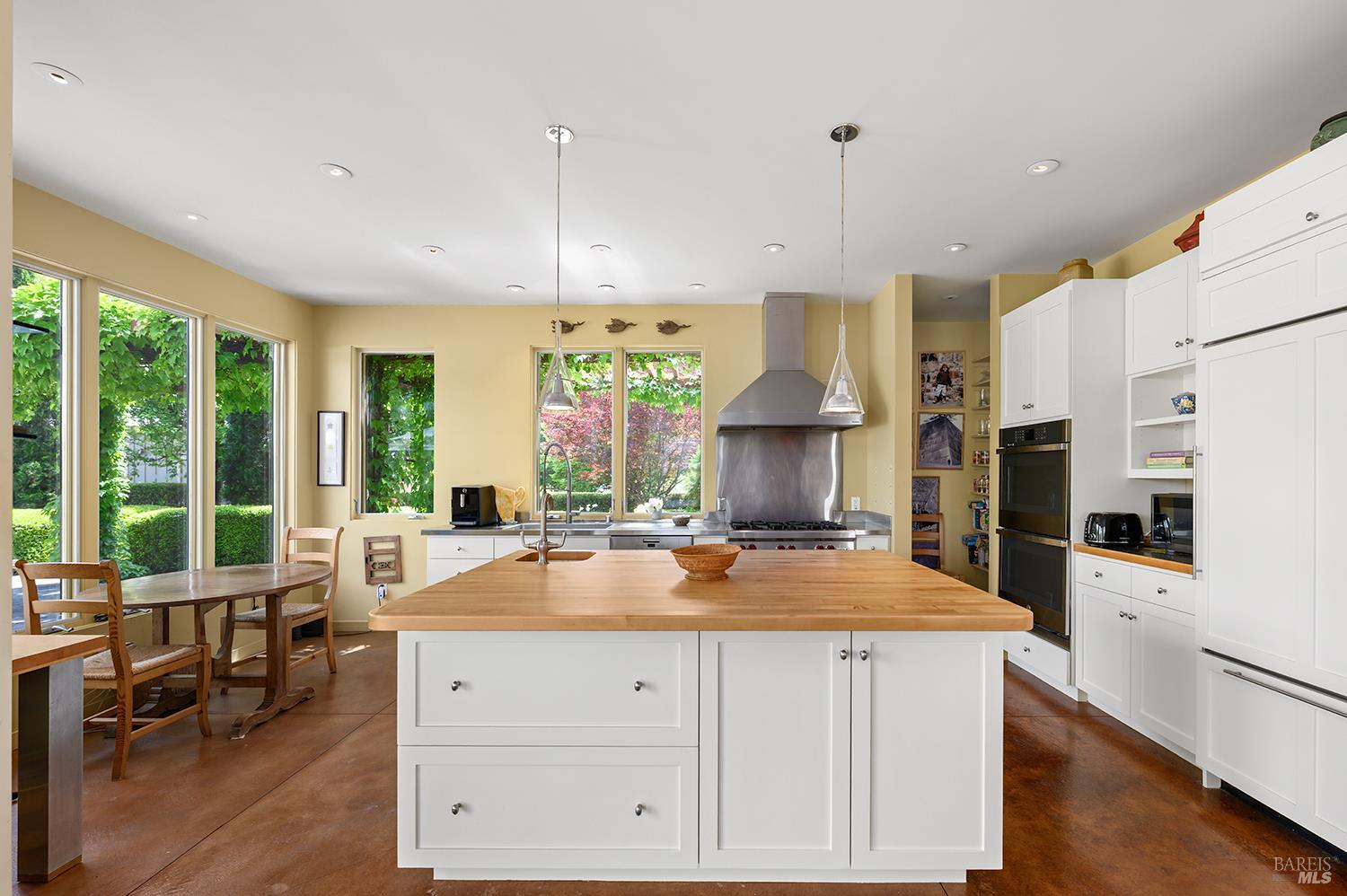 6003-6017 Red Winery Road Geyserville, CA 95441 - Photo 13 of 97 a kitchen with stainless steel appliances a stove a refrigerator a sink and white cabinets with wooden floor