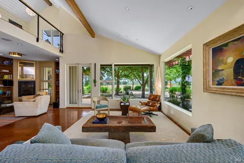 a view of a porch with furniture and floor to ceiling window