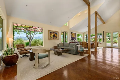a view of living room with furniture and a floor to ceiling window
