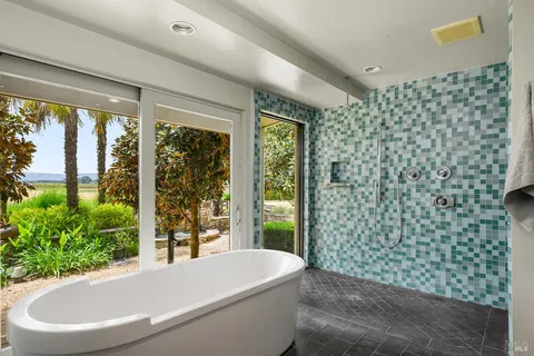 a dining hall with stainless steel appliances granite countertop a stove and a wooden floors