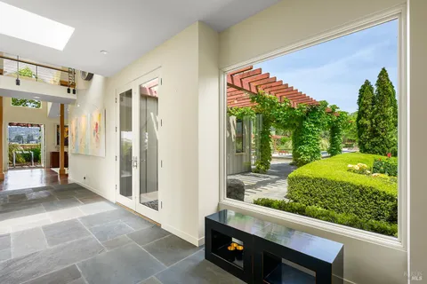 a kitchen with stainless steel appliances a stove a refrigerator and wooden floor