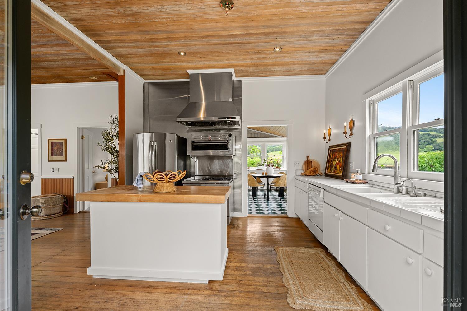 6003-6017 Red Winery Road Geyserville, CA 95441 - Photo 58 of 97 a dining hall with stainless steel appliances granite countertop a stove and a wooden floors