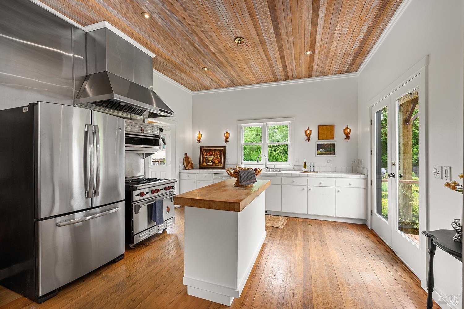 6003-6017 Red Winery Road Geyserville, CA 95441 - Photo 59 of 97 a kitchen with stainless steel appliances a refrigerator a sink dishwasher a stove and white countertops with wooden floor