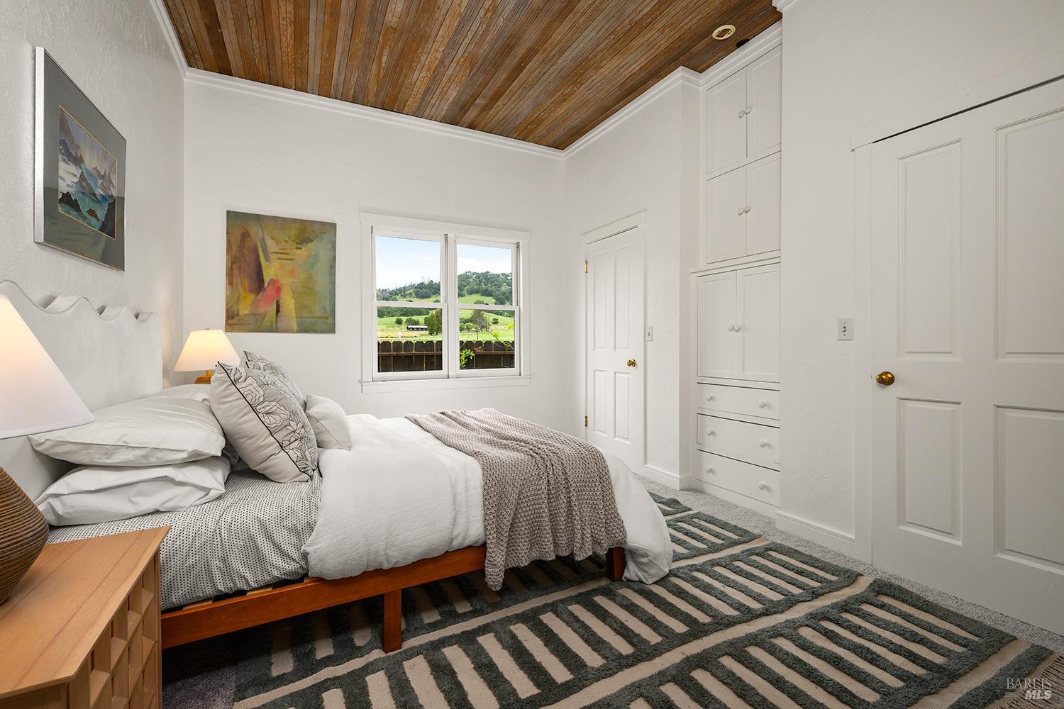 6003-6017 Red Winery Road Geyserville, CA 95441 - Photo 64 of 97 a bedroom with a bed and wooden floor