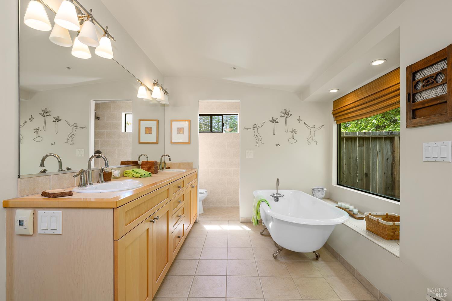 6003-6017 Red Winery Road Geyserville, CA 95441 - Photo 76 of 97 a spacious bathroom with a granite countertop sink and a mirror