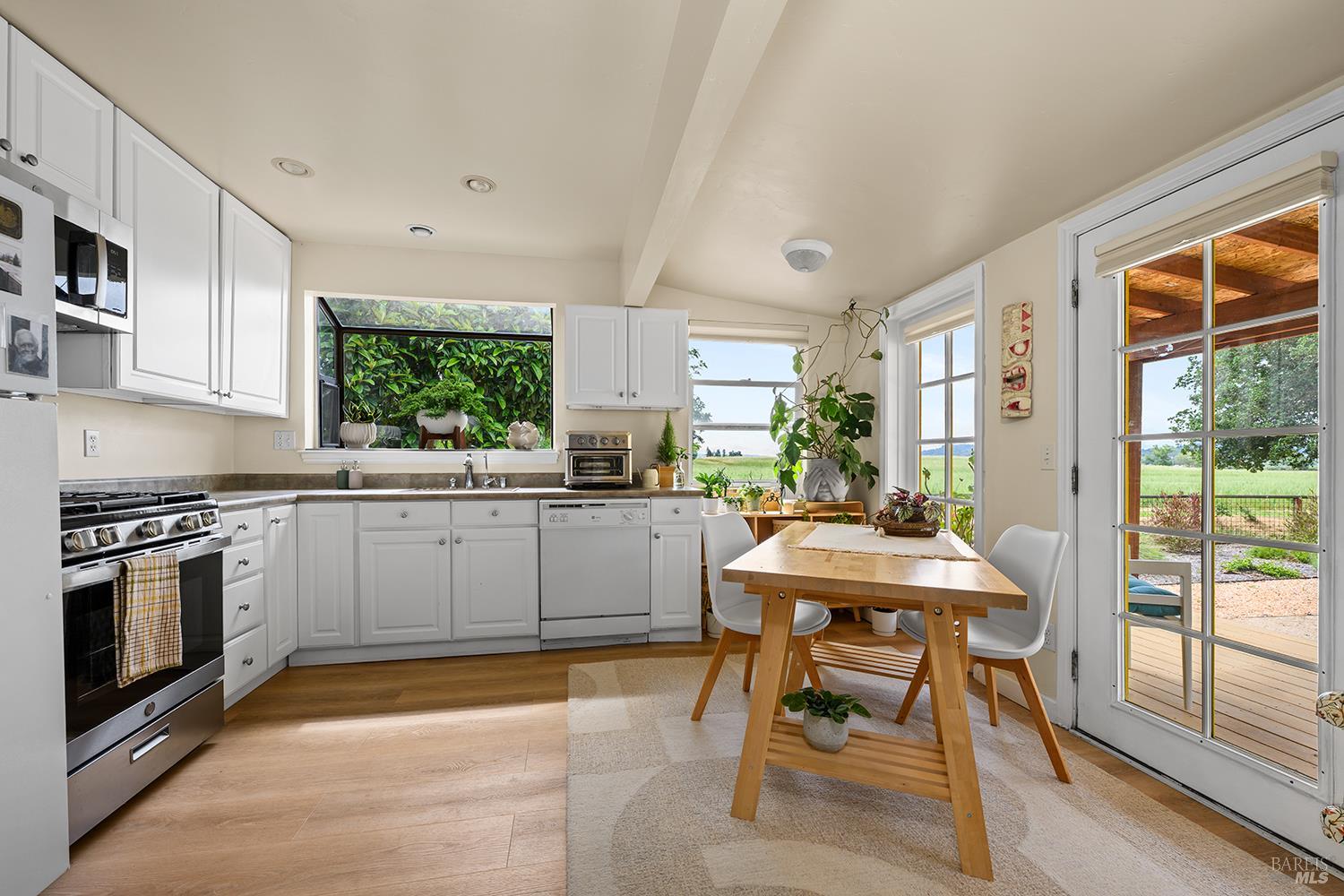 6003-6017 Red Winery Road Geyserville, CA 95441 - Photo 84 of 97 a kitchen with a table chairs stove and cabinets