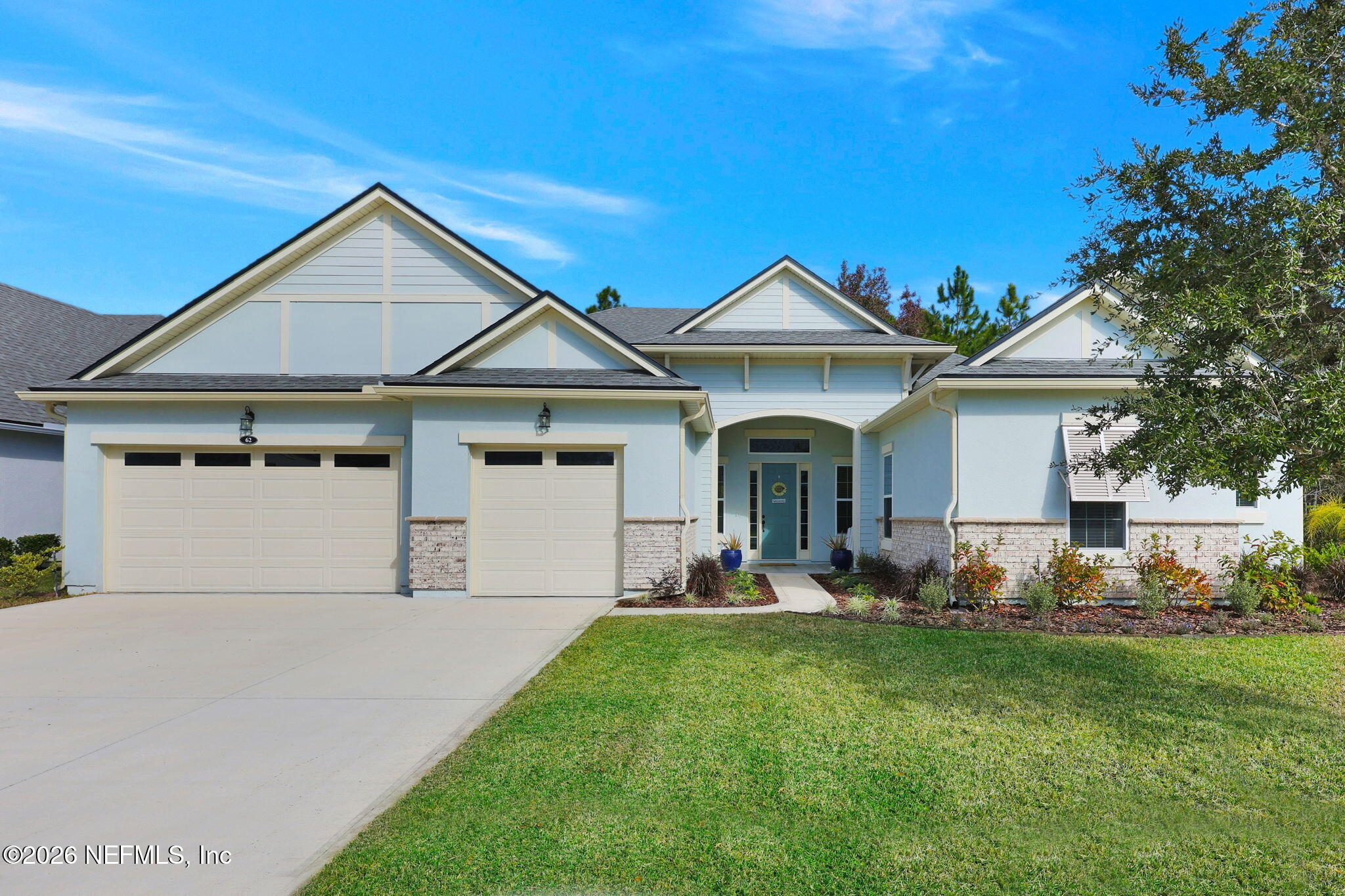 62 Broadleaf Lane St. Johns, FL 32259 - Photo 2 of 62 a front view of a house with a garden and plants
