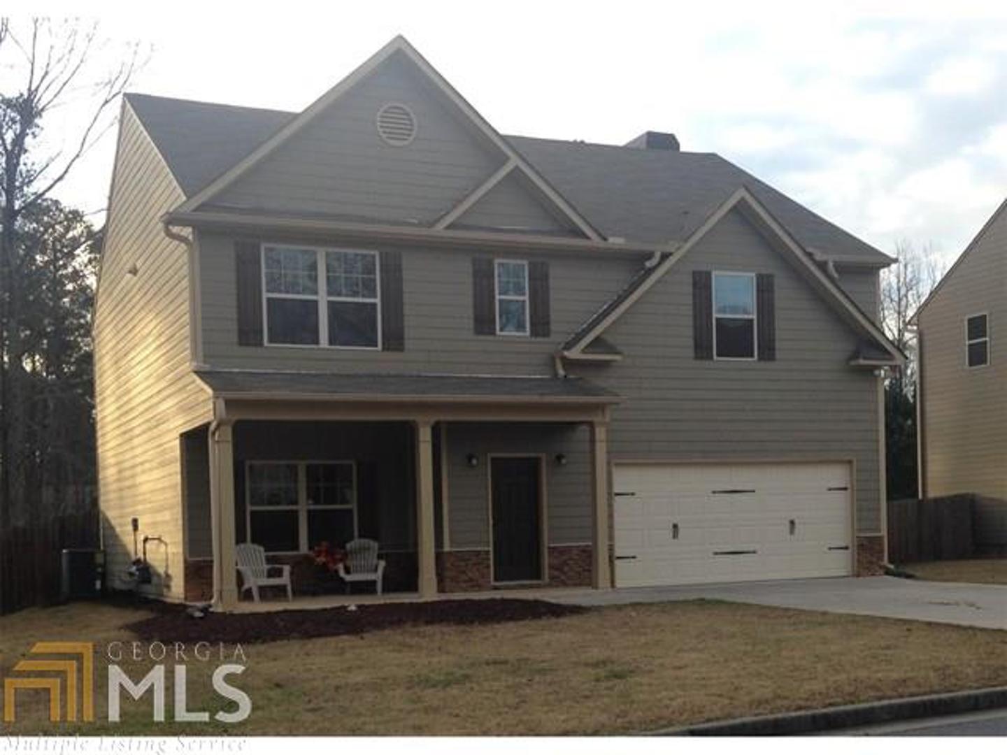 1880 Ruby Mountain Street, Unit 34 Powder Springs, GA 30127 - Photo 1 of 1 a front view of a house with a yard