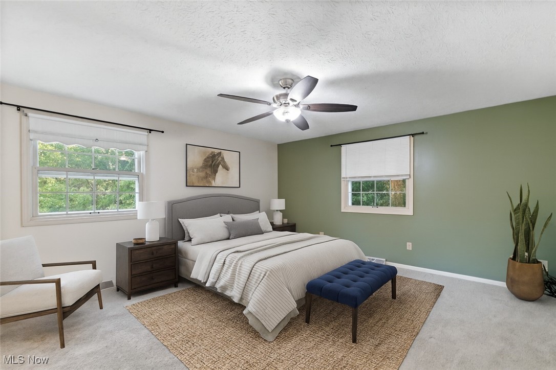 515 Oneida Avenue Northwest Canton, OH 44708 - Photo 8 of 28 Bedroom with multiple windows, light carpet, a ceiling fan, and a textured ceiling. virtually staged