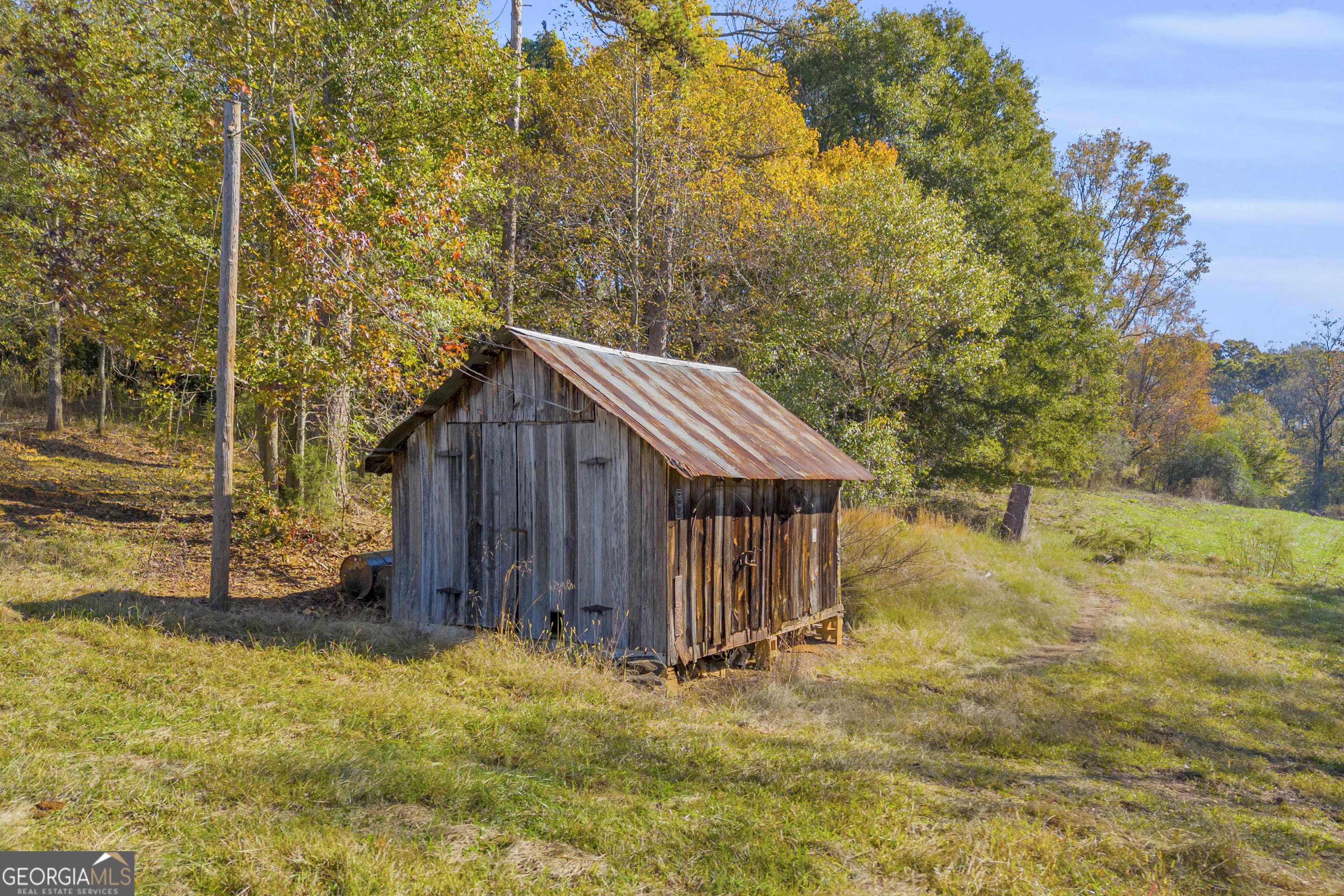 1129 Lord Road Commerce, GA 30530 - Photo 14 of 30 a wooden house with tall trees