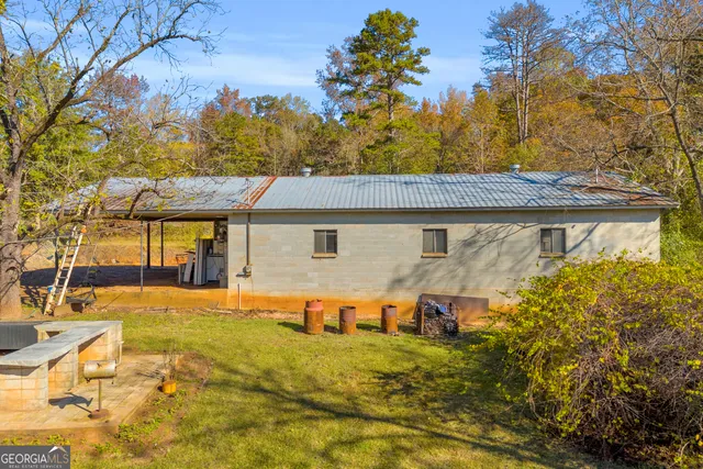 a brick house with a large tree in front of it
