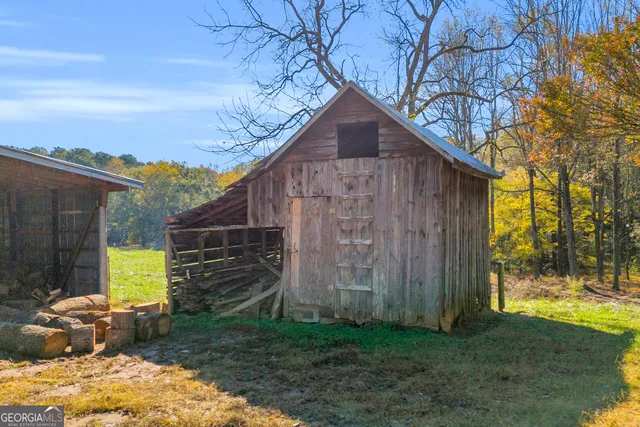 a view of a swimming pool with a patio and a yard