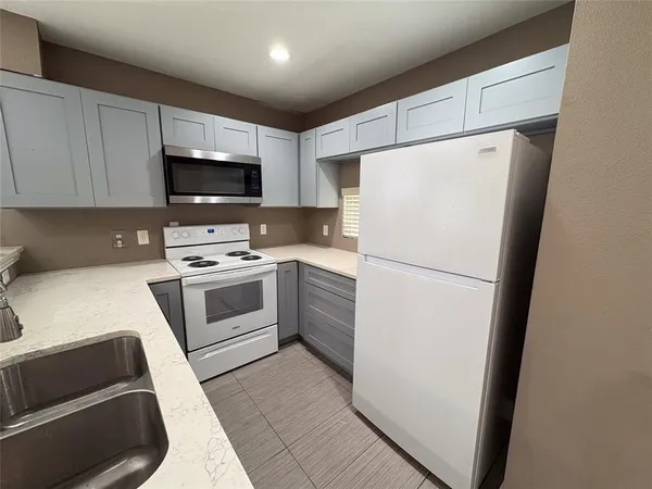 a white refrigerator freezer sitting inside of a kitchen