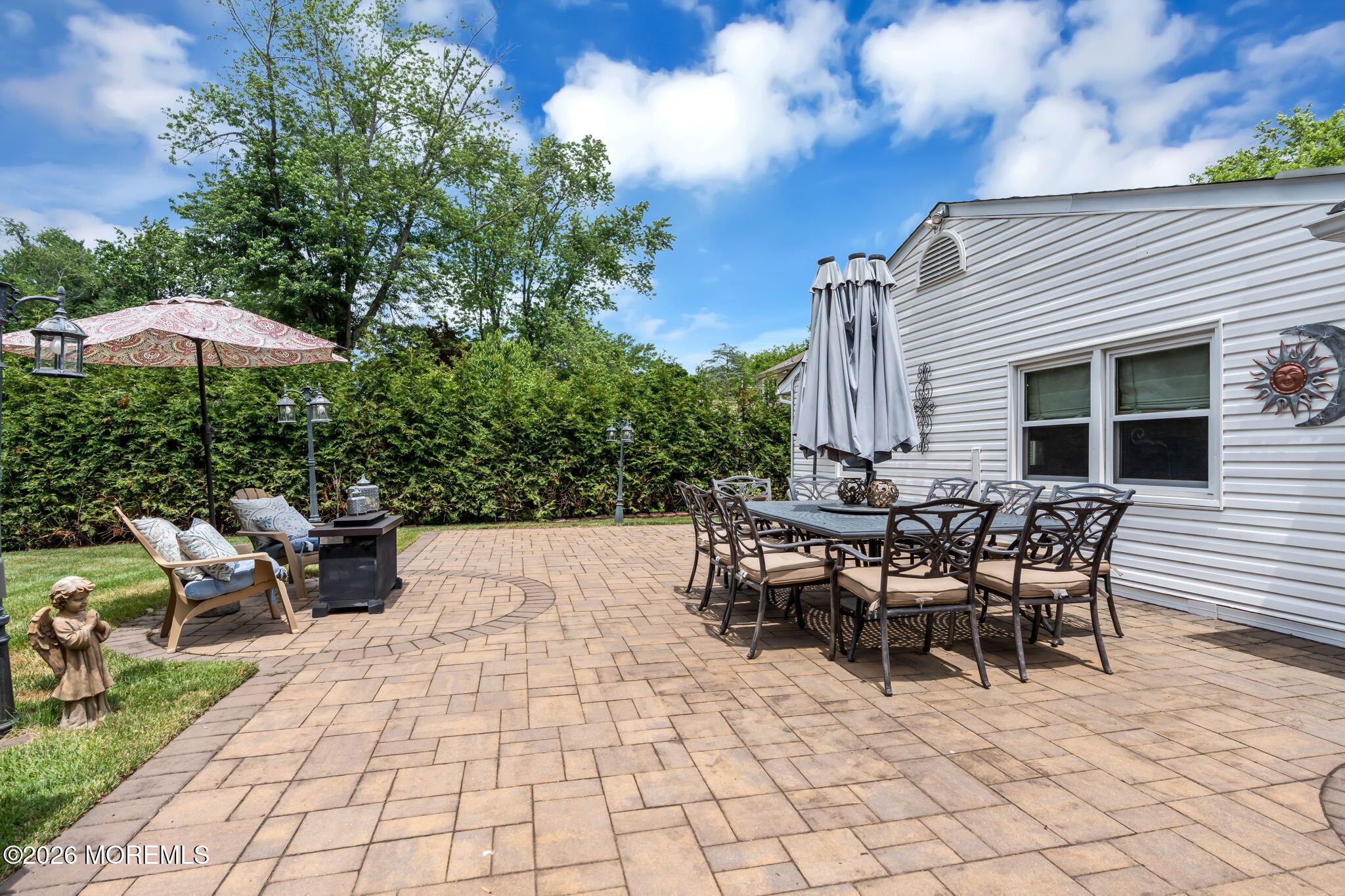 8 Owens Road Marlboro, NJ 07746 - Photo 33 of 39 a view of a patio with table and chairs near a yard