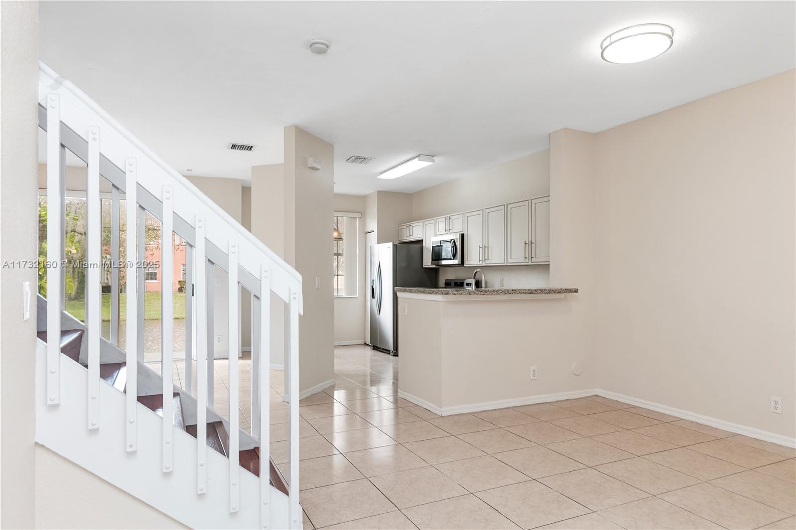 Spring Tree Sunrise, FL 33351 - Photo 11 of 44 a view of kitchen with furniture and refrigerator